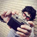 Hipster zombie taking a selfie, with a retro effect