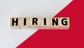 HIRE word made from building blocks on red and white background Royalty Free Stock Photo