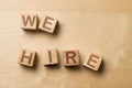 We Hire written on wooden cube blocks on office table - human resources or job vacancy concept