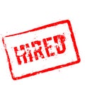 Hired red rubber stamp isolated on white. Royalty Free Stock Photo
