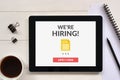 We are hiring apply now concept on tablet screen with office obj Royalty Free Stock Photo