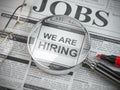 We are hiring. Job search and employment concept. Magnified glass with jobs classified ads in newspaper