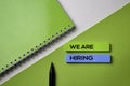 We Are Hiring text on top view office desk table of Business workplace and business objects