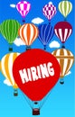 HIRING written on hot air balloon with a blue sky background.