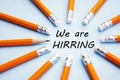 We are hiring Yellow pencils over blue background with the inscription we are hiring.