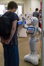 Hiroshima,Japan - May 23, 2017: Woman communicates with a robot Royalty Free Stock Photo