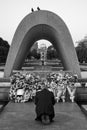 Man prays in front of the Memorial Cenotaph for the A-bomb Victims in Peace Park. Hiroshima. Japan