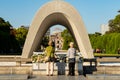 Hiroshima Peace Memorial Park. 31/10/2019. Two female japanese tourists at The Hiroshima Victims Memorial Cenotaph