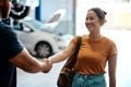 His advice saved me a lot of time and money. a woman shaking hands with a mechanic in an auto repair shop. Royalty Free Stock Photo