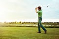 His best shot yet. a man practicing his swing on the golf course. Royalty Free Stock Photo