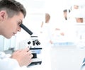 Male research scientist looks at biological samples under micros Royalty Free Stock Photo