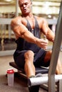 His determination never falters. a male bodybuilder using an exercise machine at the gym. Royalty Free Stock Photo