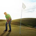 His final play for the day. a young man spending the day on a golf course.