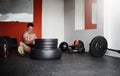 His goal is within reach. Full length shot of a handsome and muscular young man pulling weights in the gym. Royalty Free Stock Photo