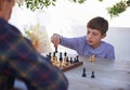 His granddad is a worthy adversary. Shot of a young boy playing chess with his grandfather. Royalty Free Stock Photo