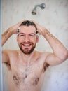 His daily grooming routine. a handsome young man having a shower at home. Royalty Free Stock Photo