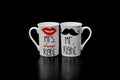 His and hers mugs on black background Royalty Free Stock Photo