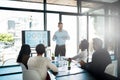 His ideas have them intrigued. a businessman giving a presentation in the boardroom.