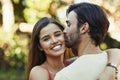 His kisses are the sweetest. Portrait of an affectionate young couple sharing a kiss outside. Royalty Free Stock Photo