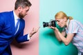 His pointer finger is the focus. Fashion shooting in photo studio. Sexy woman using professional camera. Photographer Royalty Free Stock Photo