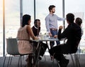 His presentations are never dull. a businessman giving a whiteboard presentation to a group of colleagues in a boardroom Royalty Free Stock Photo