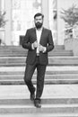 On his way to success. Walking down street. Mature hipster with beard on stairs. Bearded man in business centre