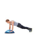 His workout plan is simple but effective. A young man doing push-ups on a bosu-ball.