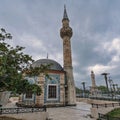 Hisar Mosque and Izmir Clock Tower in Konak Square, Izmir, Turkey under a cloudy sky. Royalty Free Stock Photo