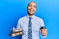 Hispanic adult business man holding take away coffee and sweets smiling and laughing hard out loud because funny crazy joke Royalty Free Stock Photo