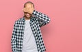 Hispanic adult man wearing casual clothes smiling and laughing with hand on face covering eyes for surprise Royalty Free Stock Photo