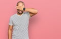 Hispanic adult man wearing casual clothes smiling and laughing with hand on face covering eyes for surprise Royalty Free Stock Photo