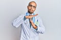 Hispanic adult man wearing doctor uniform and stethoscope doing time out gesture with hands, frustrated and serious face Royalty Free Stock Photo