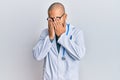 Hispanic adult man wearing doctor uniform and stethoscope rubbing eyes for fatigue and headache, sleepy and tired expression