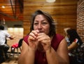 Hispanic adult woman in a restaurant waiting for the food Royalty Free Stock Photo