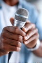 Hispanic announcer holds microphone and reads script during live event in a bright studio setting Royalty Free Stock Photo