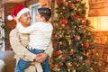 Hispanic Armed Forces Soldier Wearing Santa Hat Hugging Son