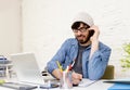 Hispanic attractive hipster businessman working at home office talking on mobile phone Royalty Free Stock Photo