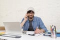 Hispanic attractive hipster businessman working at home office using mobile phone Royalty Free Stock Photo