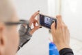 Hispanic Bald young woman taking photos with her cellphone in the washroom Royalty Free Stock Photo