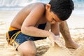 Hispanic boy building a sand castle Royalty Free Stock Photo