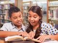 Excited Hispanic Boy and Girl Having Fun Studying Together In The Library Royalty Free Stock Photo