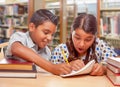 Hispanic Boy and Girl Having Fun Studying In The Library Royalty Free Stock Photo