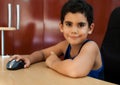 Hispanic boy working on a computer at home Royalty Free Stock Photo