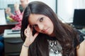 Hispanic brunette office worker sitting by desk Royalty Free Stock Photo