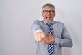 Hispanic business man with grey hair wearing glasses laughing at you, pointing finger to the camera with hand over body, shame Royalty Free Stock Photo