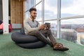 Hispanic Business Man Using Tablet Computer Sit n Front Panoramic Window Happy Smiling Businessman Royalty Free Stock Photo