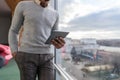 Hispanic Business Man Using Tablet Computer Stand in front Panoramic Window Businessman In Coworking Center Royalty Free Stock Photo