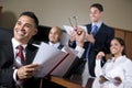 Hispanic business people in boardroom smiling Royalty Free Stock Photo