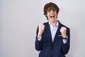 Hispanic business young man wearing glasses excited for success with arms raised and eyes closed celebrating victory smiling Royalty Free Stock Photo