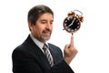 Hispanic Businessman Balancing Vintage Clock